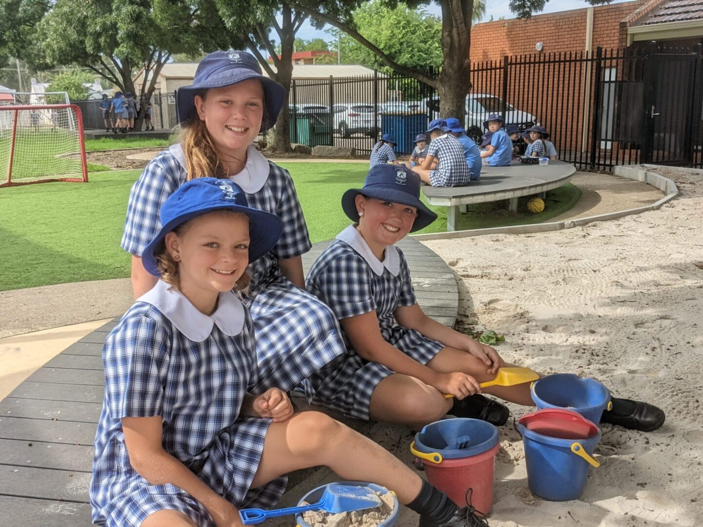 St Josephs Primary School girls in the playground sandpit.